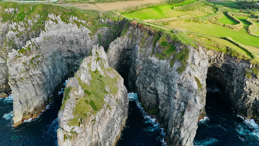 Steep coastal rock walls and deep inlets at Cape Cintrao on north coast of Sao Miguel, Azores