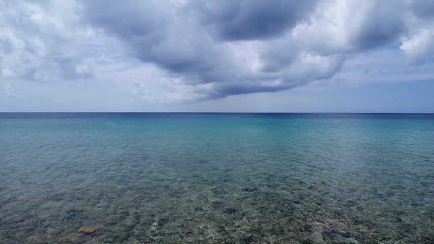 Aerial panoramic footage of boats navigating over shallow Caribbean waters with light blue tones and visible sandbanks. Tropical travel and marine tourism concept.