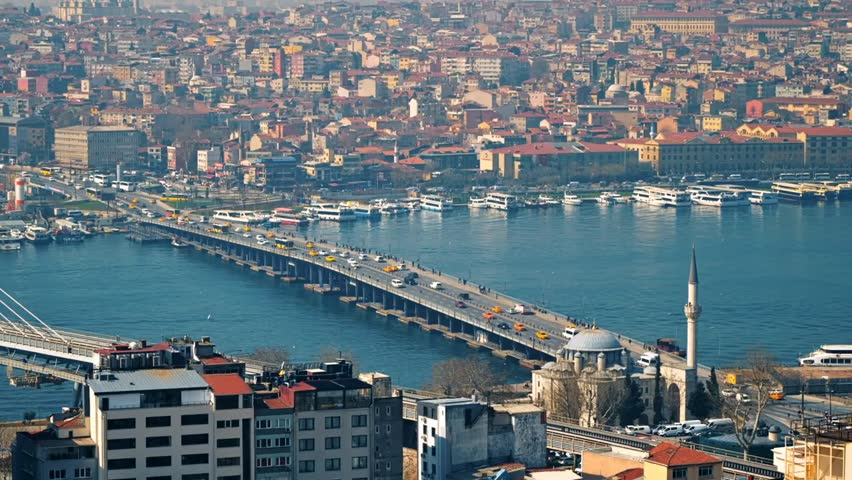 Cityscape of Istanbul, Turkey showing the Bosporus Strait, bridges, moving cars, and urban buildings, capturing dynamic city life and architecture.