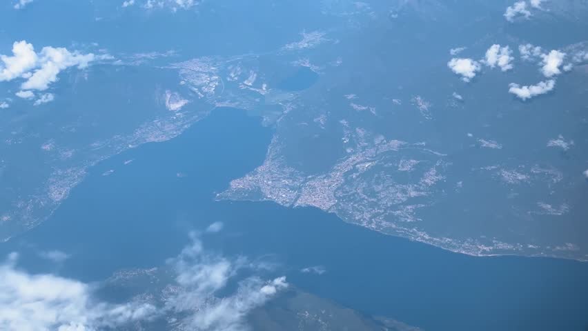 plane flies calm blue lake under cloudy sky natural air travel rome to easyjet beauty scenic flight aircraft window seat clouds transportation aviation water body journey
