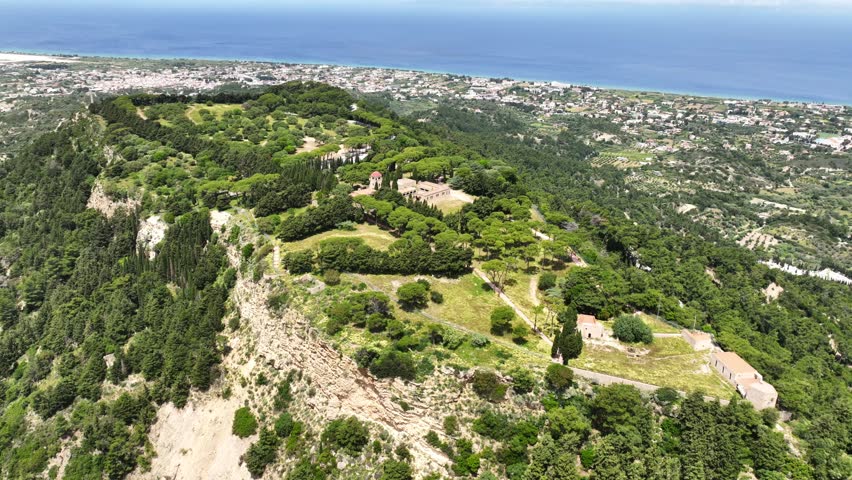 Aerial drone cinematic video of iconic Monastery of Filerimos, built uphill in ruins of ancient village of Ialysos, Rhodes island, Dodecanese, Greece
