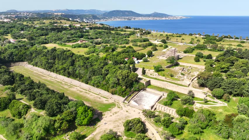 Aerial drone cinematic video of archaeological site of Acropolis, Odeon and Ancient stadium of Rhodes in area of Monte Smith, Rhodes island, Dodecanese, Greece