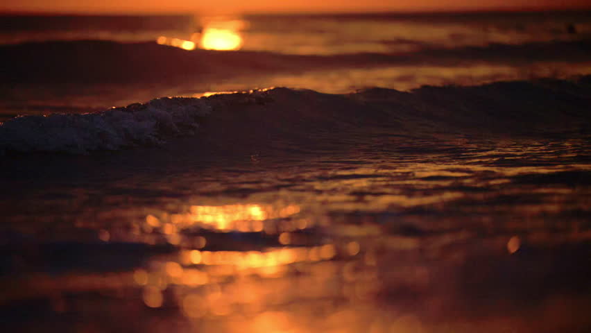 Golden sunset waves hitting the shore in a cinematic and mysterious seascape.