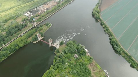 Drone Rotating Downward above River Dam