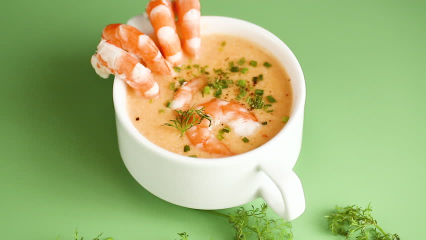 Hot savory shrimp chowder with dill and chives in elegant ceramic cup