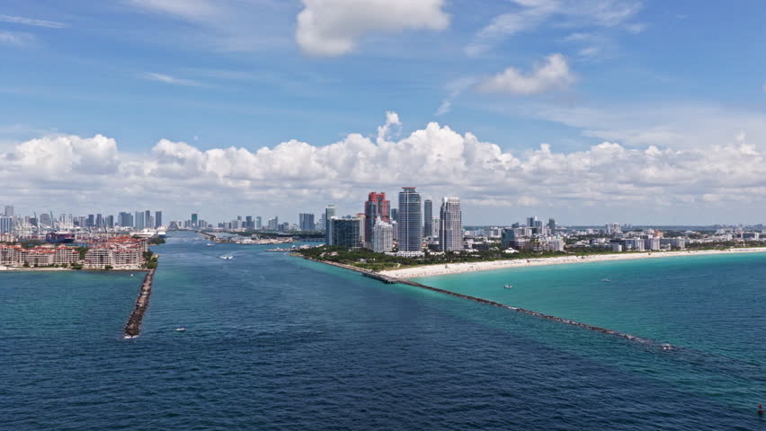 Miami skyscrapers above the coastline. Miamis coastal landscape from above. Aerial view of Miami beach and ocean.