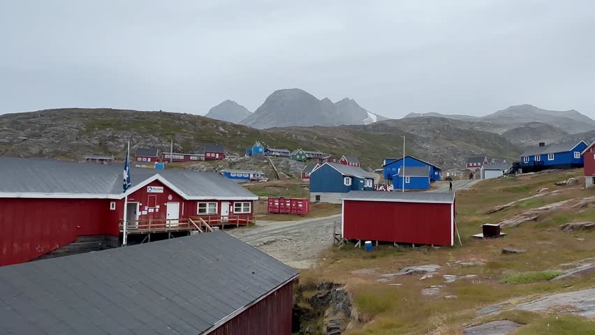 The traditional town of Ammassalik in Greenland features vibrant, colorful houses set against the dramatic backdrop of the Arctic Ocean. This picturesque settlement showcases local architecture and culture while highlighting the beauty and isolation of life in the remote polar regions.