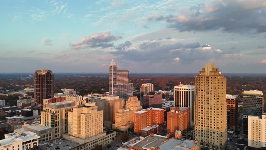 Aerial view of Raleigh city skyline under soft evening light in North Carolina, USA.