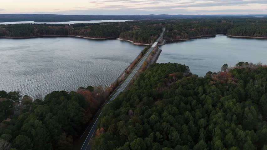 Aerial view of a bridge crossing a lake surrounded by forest in the United States