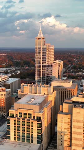 Vertical drone shot of an iconic Raleigh skyscraper rising above the city.