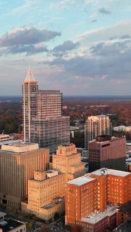 Vertical drone shot of Raleigh skyline under dramatic clouds in North Carolina, USA.