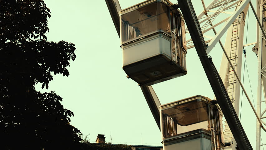 Close-up of a ferris wheel rotating in Budapest, Hungary, with cinematic motion, urban atmosphere, and evening city vibes.