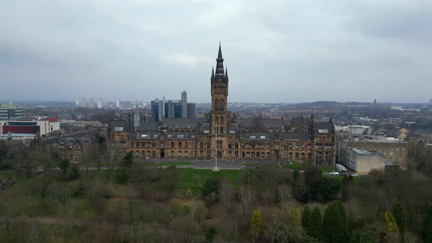 Aerial view of the University of Glasgow with the city in the background, showcasing historic architecture, campus grounds, and urban Scottish landscape.