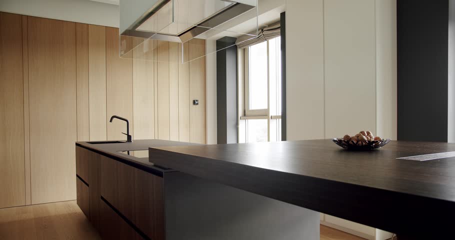 Beautiful kitchen interior with new stylish furniture. Real Luxury kitchen with an island. Modern interior in luxury house. Interior of a minimalist kitchen. Modern Open Concept Home Interior.