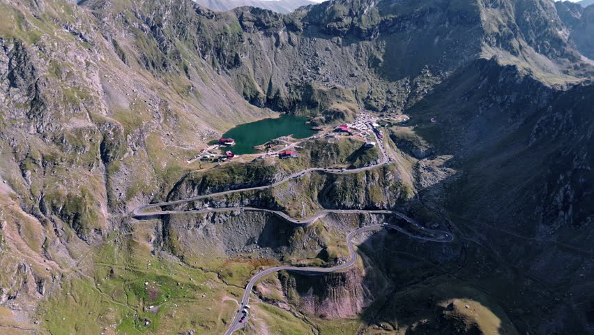 Winding Transfagarasan road through mountains, scenic aerial daytime view