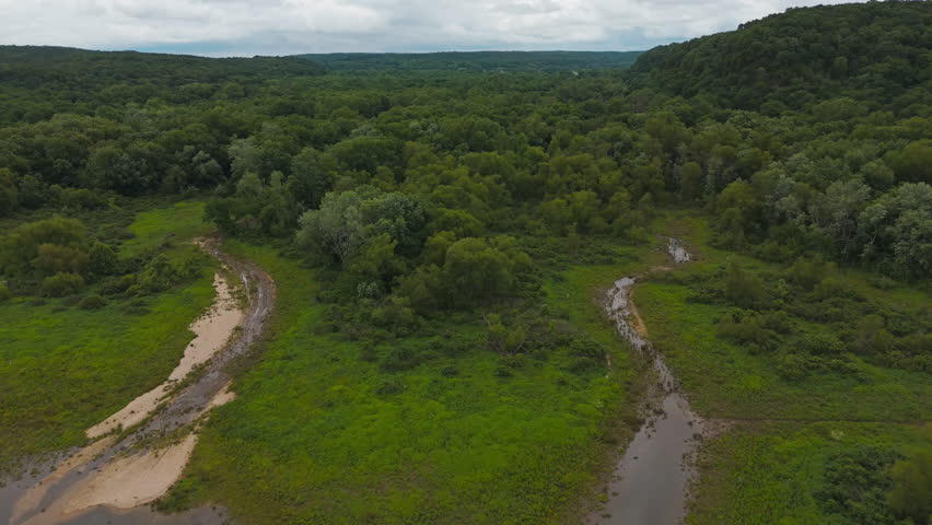 Lush Green Vegetation With Muddy Shallow River Near Tagg Flats In Oklahoma, USA. Aerial Shot