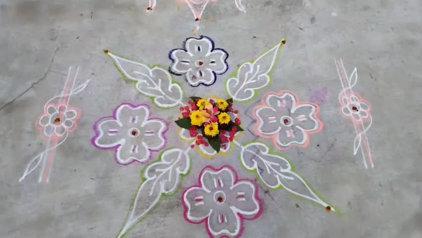 Footage of rangoli ,a Hindu Decoration with colored powders,flowers,cow dung etc in all festivals,events,functions as a tradition being drawn.