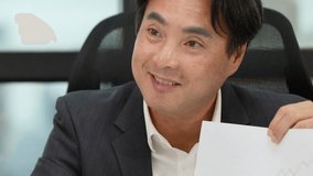 Professional man in suit discusses financial chart in bright modern office, mid-shot, natural lighting - Powered by Shutterstock - Get 15% off with code: PIKWIZARD15