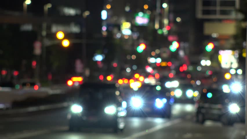 TOKYO, JAPAN - JULY 2025 : Blurred view of street traffic at night. Many cars passing on busy road in downtown area. Transportation, urban traffic and nightlife concept video. Time lapse shot.