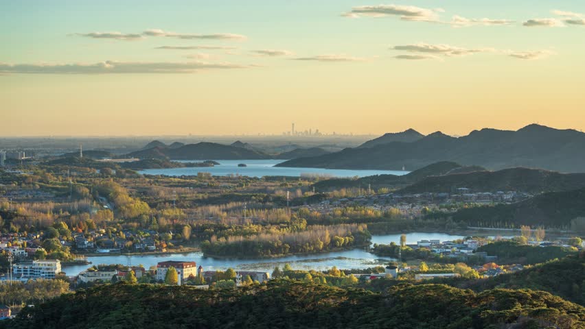 Beijing, China - 1st November 2025 - Overlooking Beijing cityscape over Huairou reservoir and mountains from day to night