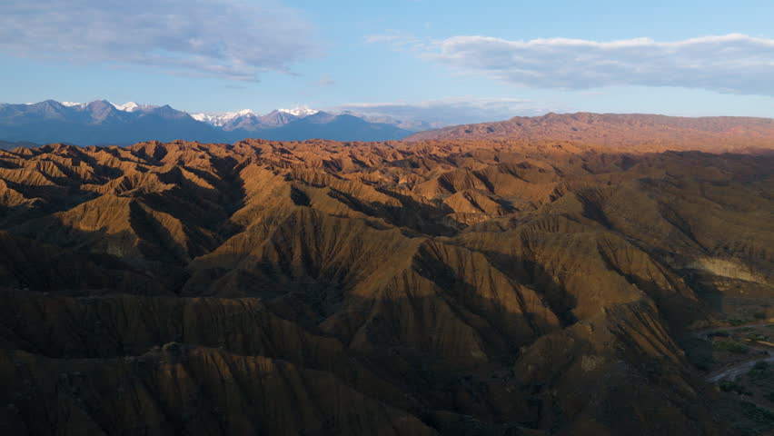 Aerial View Of A Man Across The Surreal Landscape Of Ak-Sai Canyon At Sunrise In Kyrgyzstan.