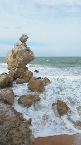 stormy sea surf on the coast with rocks slow motion
