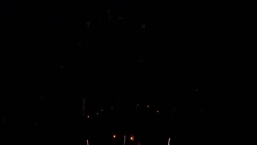 Amazing beautiful colorful firework display over sea on celebration night. Fireworks show for happy new year, 4k footage.