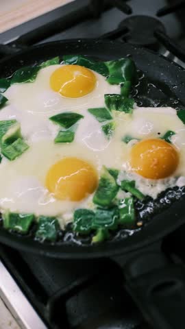 Frying Eggs with Green Bell Pepper in Pan on Gas Stove, Homemade Breakfast Cooking, Fresh Eggs Sunny Side Up