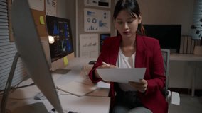 Dedicated asian businesswoman working late at night, comparing financial data on a paper report with charts displayed on her computer monitor - Powered by Shutterstock - Get 15% off with code: PIKWIZARD15