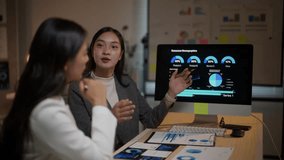 Young asian businesswomen working together in the office late at night. One woman explains consumer demographics data on a computer screen - Powered by Shutterstock - Get 15% off with code: PIKWIZARD15
