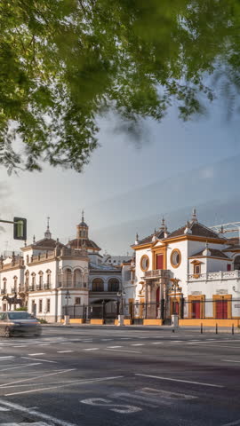 Plaza de Toros de la Real Maestranza de Caballeria de Sevilla timelapse hyperlapse. Historic bullring in Seville, Spain, known for its bullfighting festivals. Traffic passing in front of its facade