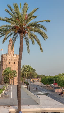 Torre del Oro timelapse hyperlapse, a dodecagonal military watchtower in Seville, Spain. Built by the Almohads to control Guadalquivir River access. Historic landmark at evening before sunset