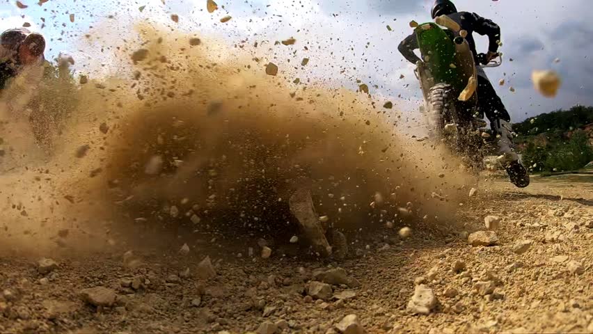 Vehicle kicking up dust and debris, showcasing the thrilling movement and energy of off-road driving in a rugged terrain environment