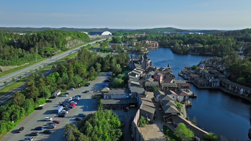 Aerial view of Abra Havn pirate village in Kristiansand Norway. Drone shot over wooden harbor houses and canals at Dyreparken.