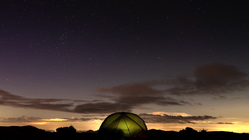Wild camping night sky timelapse with stars and clouds