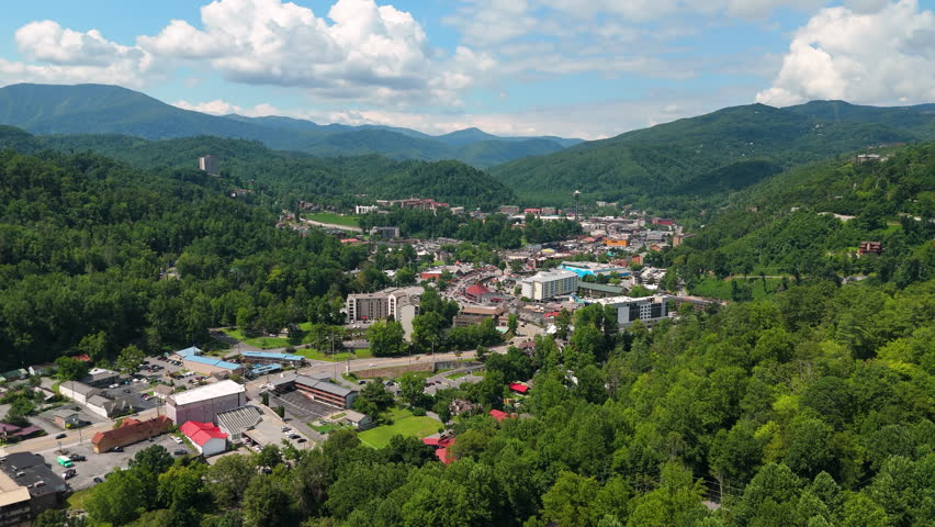 Aerial panorama of Gatlinburg, Tennessee with observation tower, town tourist infrastructure and Smoky Mountains National Park nearby.