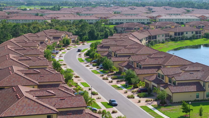 Florida suburban condos with car parking, highlighting residential architecture and real estate expansion in American communities.