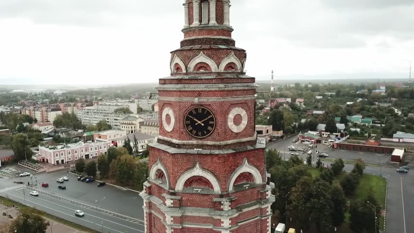 Aerial circling flight beside historic clock tower