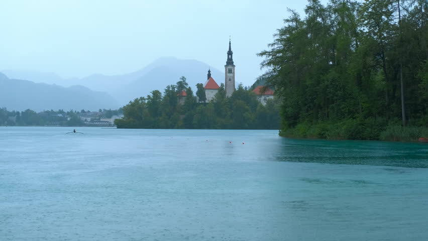 Bled island with assumption of mary pilgrimage church, slovenia. Lake bled and bled island with assumption of mary pilgrimage church during cloudy weather, with bled castle, slovenia