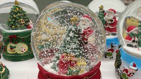 Christmas Tree Snow Globe On Mantel Evokes Cozy Vintage Holiday Nostalgia Glass Globe Houses Miniature Decorated Tree And Wrapped Present, Glittering Faux Snow, Ornate Green Base. - Powered by Shutterstock - Get 15% off with code: PIKWIZARD15