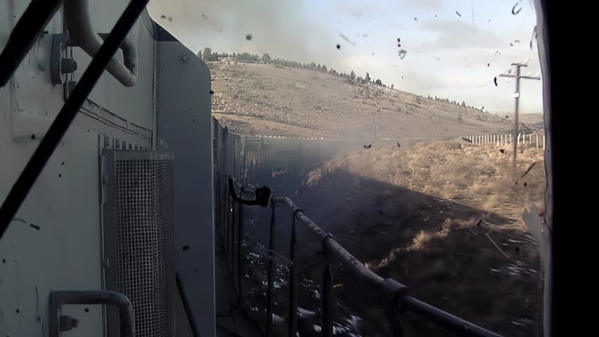 View from Locomotive Pushing Freight Train through Patagonian Landscape with Light Snow - 4K
