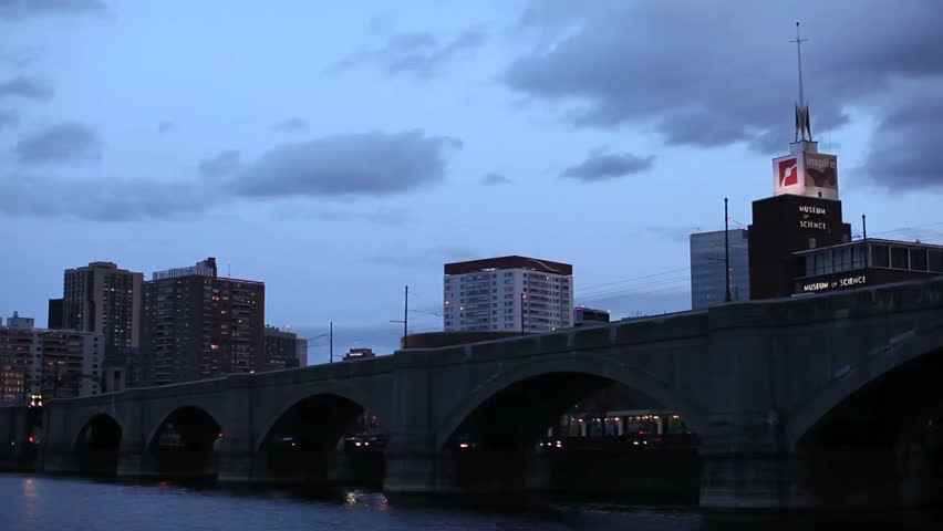 A green line train passes in front of the Museum of Science in Boston, Massachusetts.