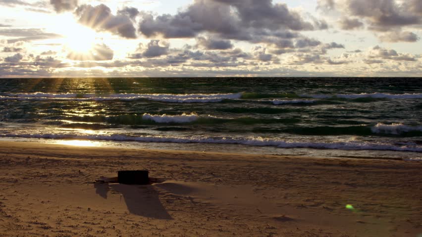 Windy Lake Michigan in Empire, Michigan during cloudy sunset with stable video shot.