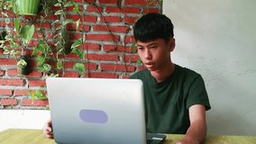 An active Asian teenager engaging through a webcam, ideal for e-learning platforms, social media connectivity ads, remote family communication features, and youth-led digital business campaigns - Powered by Shutterstock - Get 15% off with code: PIKWIZARD15