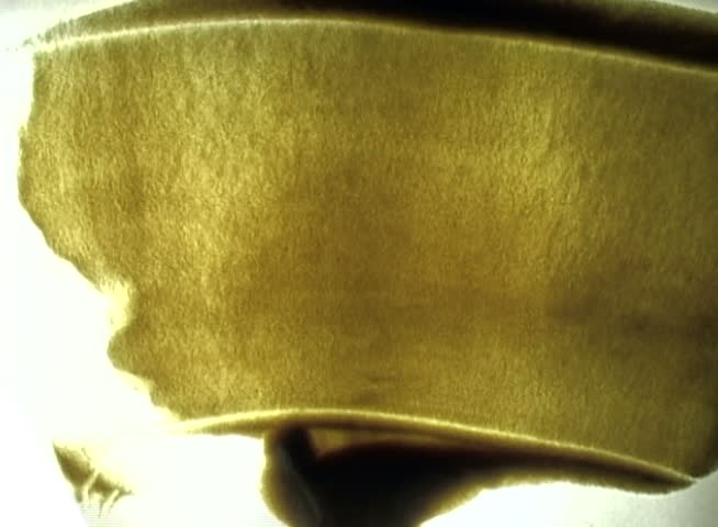 the hand draws a sea silhouette on a sandy surface  