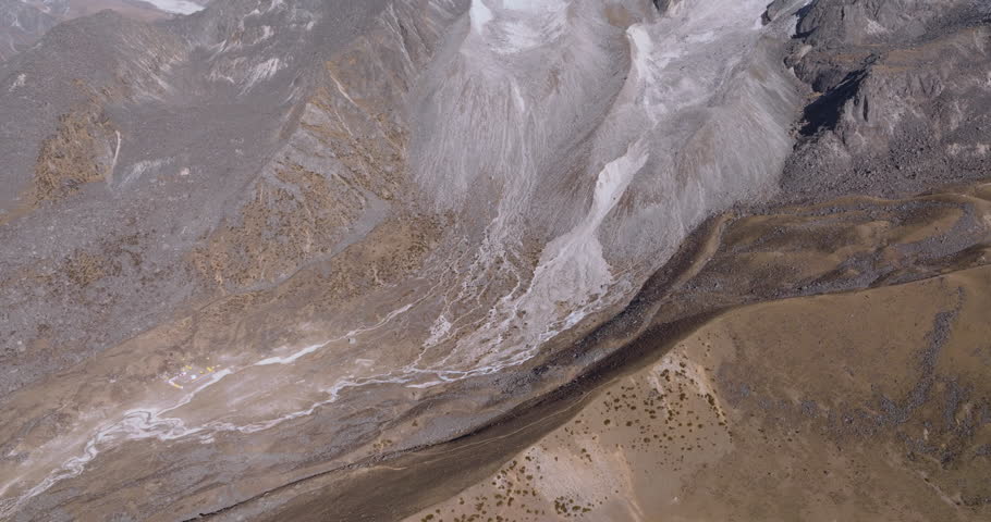 Aerial panning shot revealing the Himalayan landscape of Nepal, highlighting Mount Ama Dablam and Mount Everest in the backdrop. Wide scenic view ideal for travel films and documentaries.