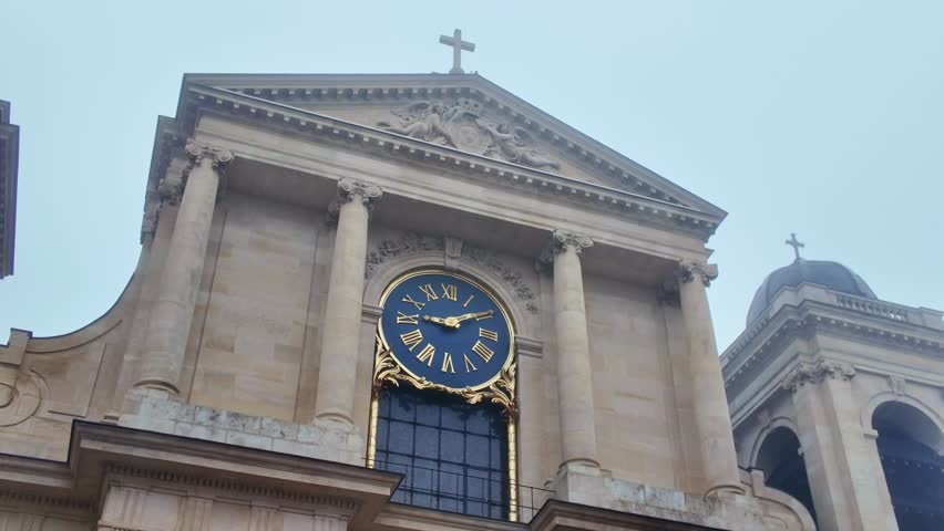 Tilt-down shot from cross and clock to entrance of Notre-Dame Versailles church