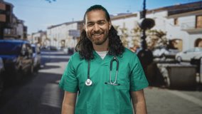 Young man wearing green scrubs and stethoscope forms binoculars with hands on a sunny city street, smiling broadly; playful curiosity. - Powered by Shutterstock - Get 15% off with code: PIKWIZARD15