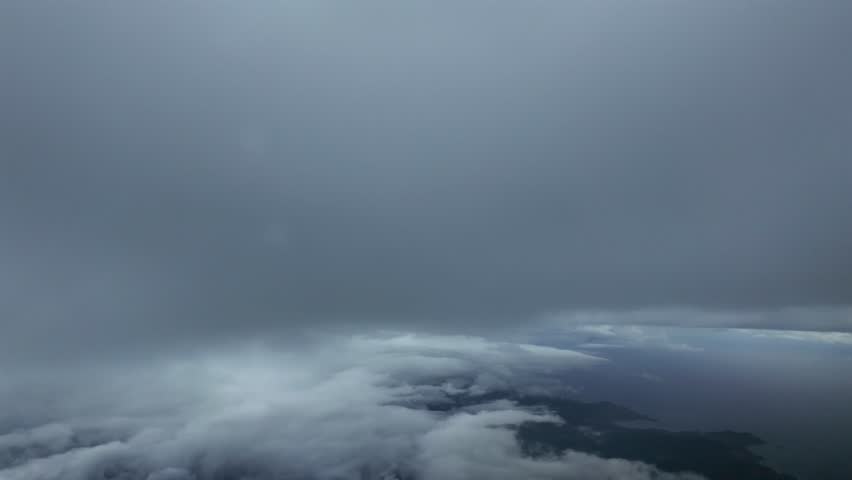 in immersive cockpit view taken while flying between layers of cold winter clouds during the dencent.