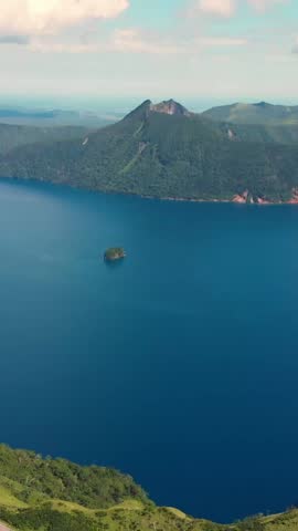 Vertical Aerial fly Lake Mashu Caldera in Japan Hokkaido Volcanic Lake, Misty Mountains, slow motion long exposure, Nature